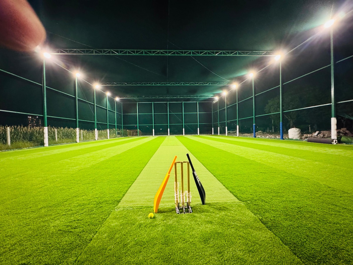 Turf cricket pitch with stumps