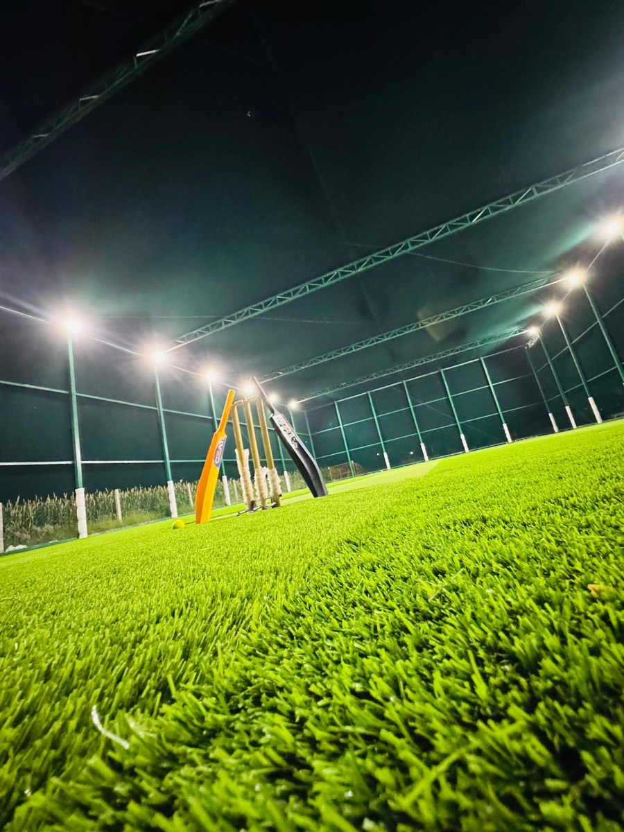 Cricket stumps on the turf pitch